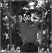 Eldrick “Tiger” Woods thrust his arms triumphantly in the air